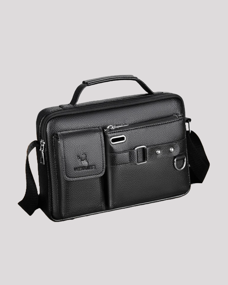 Side angled view of black leather messenger bag showing compartments and strap