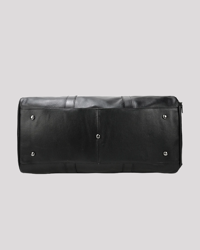 Bottom view of black leather travel duffel bag with protective metal studs