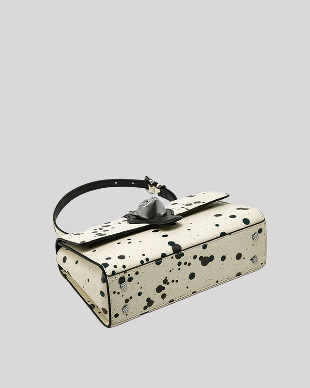 Top view of black splatter paint shoulder bag with cat clasp showing leather strap and chain by Bafelli