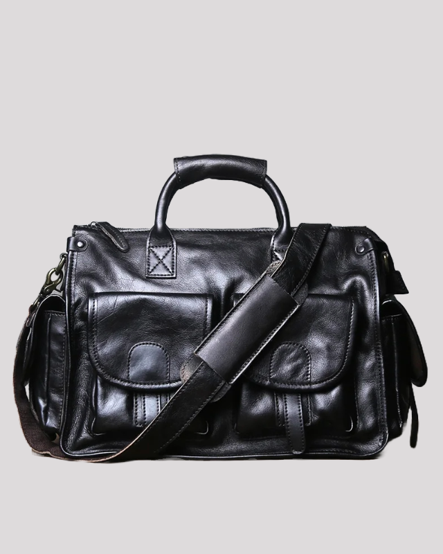 Front view of black vintage leather messenger bag with dual front flap pockets and adjustable shoulder strap