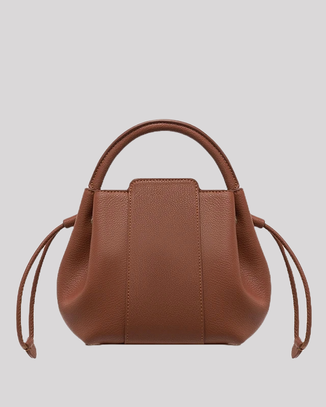 Back view of brown leather bucket bag with clean design and smooth pebbled leather finish