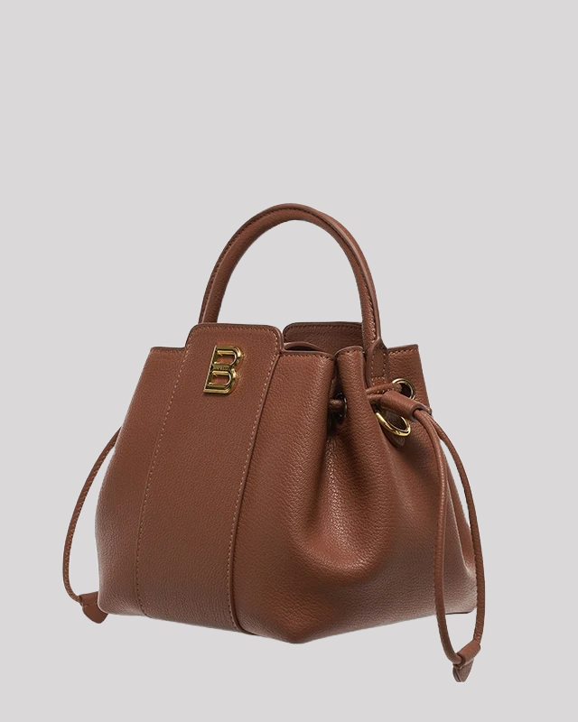 Side angle of brown leather bucket bag with gold B logo and adjustable drawstring closure