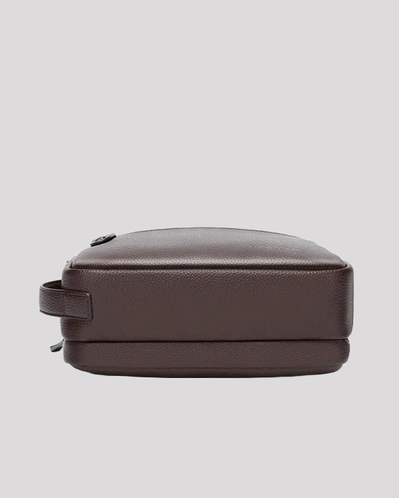 Bottom view of brown leather men’s handbag with structured flat base