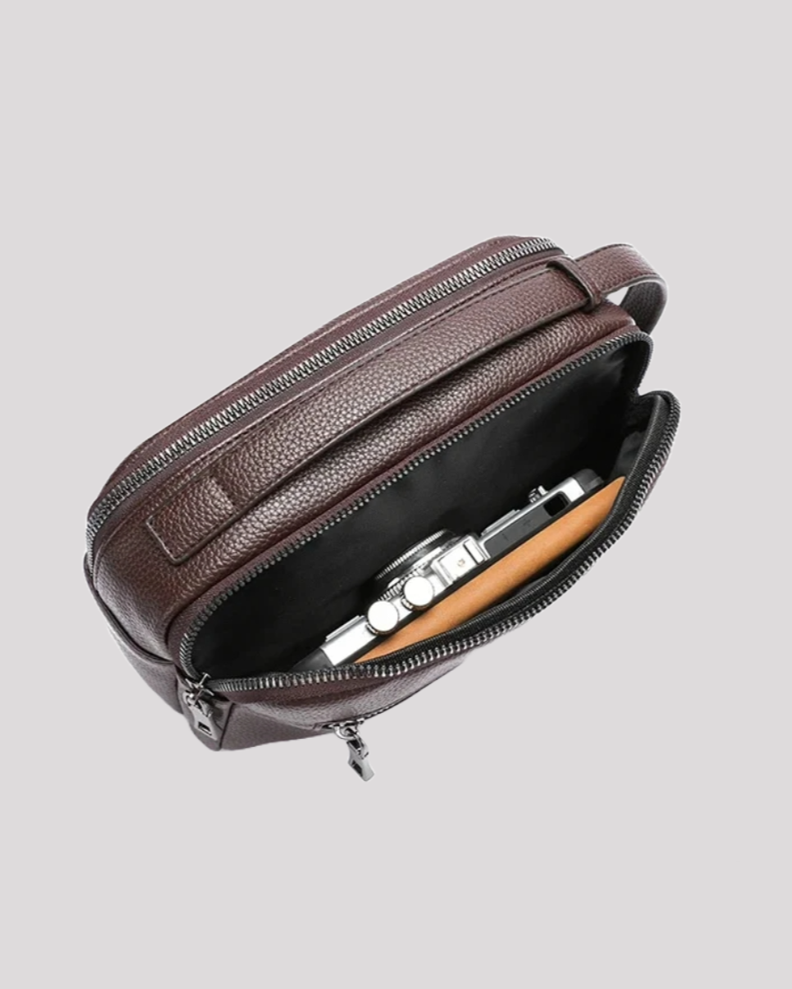 Open brown leather men’s handbag showing interior with watch and wallet