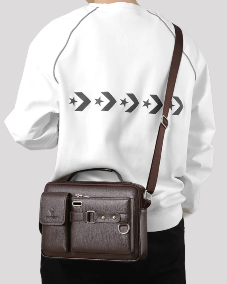 Man carrying brown leather messenger bag crossbody – back view