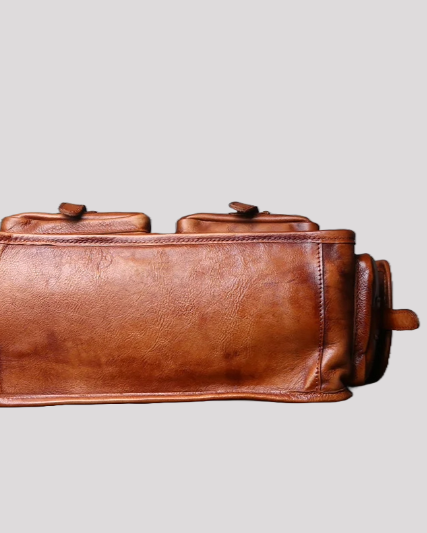 Bottom view of brown vintage leather messenger bag with reinforced leather base