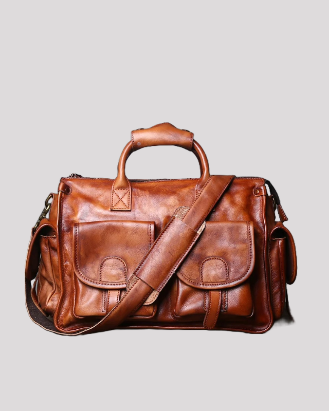 Front view of brown vintage leather messenger bag with double front flap pockets and shoulder strap
