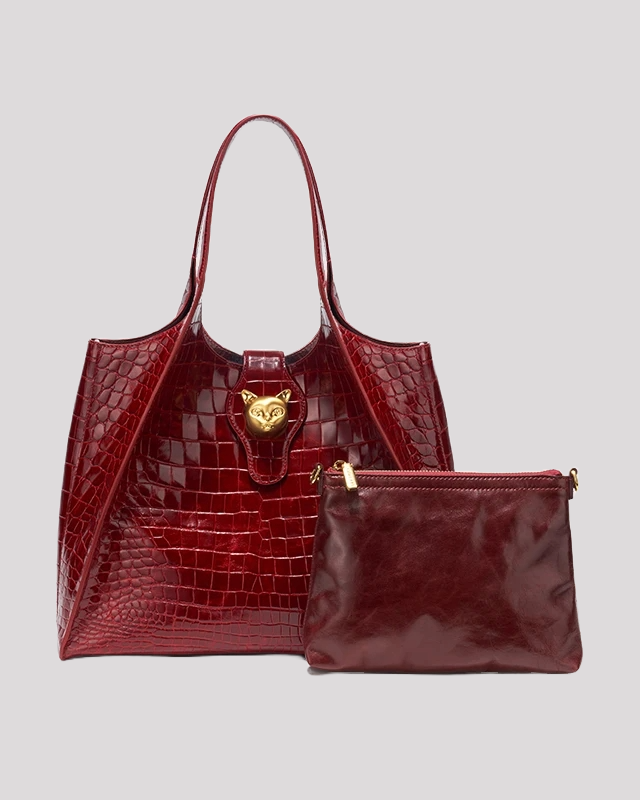 Burgundy crocodile embossed tote bag by Bafelli with gold cat-shaped lock, shown with matching detachable pouch