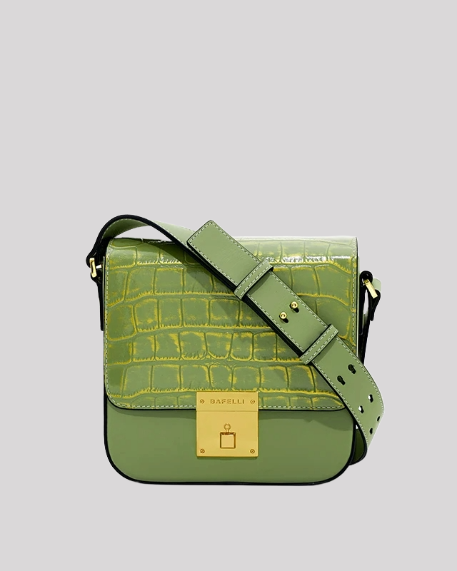 Front view of green croc-embossed shoulder bag by Bafelli with gold lock closure and structured silhouette