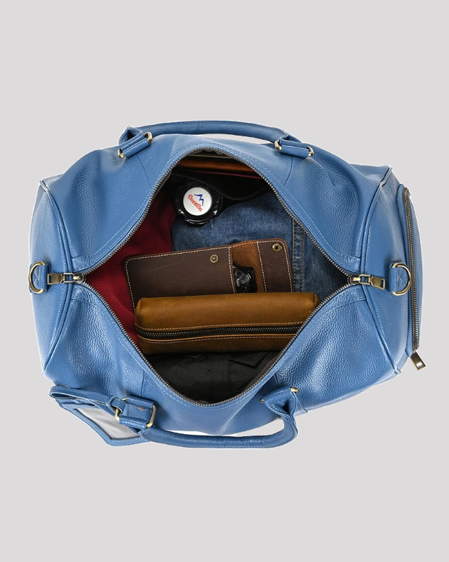Men’s blue leather travel duffle bag – top view showing packed interior with wallet and clothes