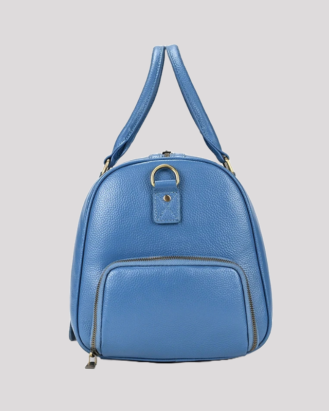 Side view of men’s blue leather travel duffle bag with front zipper pocket