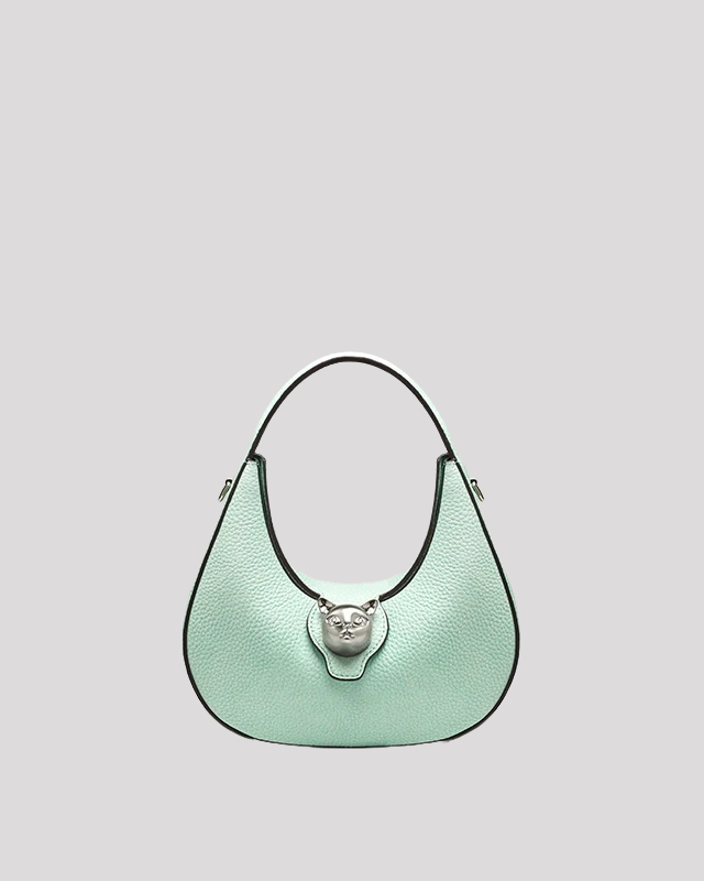 Front view of mint green leather shoulder bag by Bafelli with cat head clasp