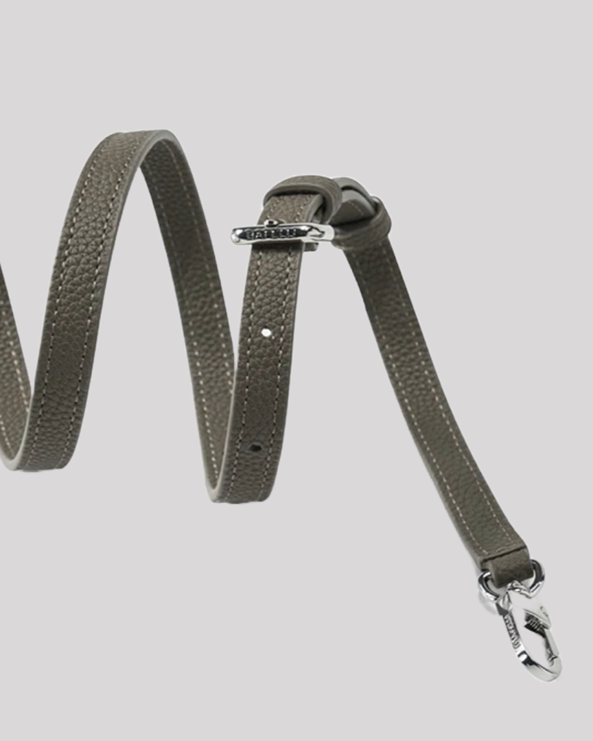 Close-up of detachable textured olive green leather strap by Bafelli with silver buckle and clasp