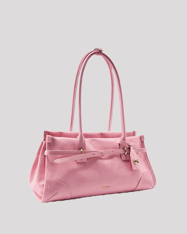 Angled view of pink leather shoulder bag by Bafelli with double handles and belt detail