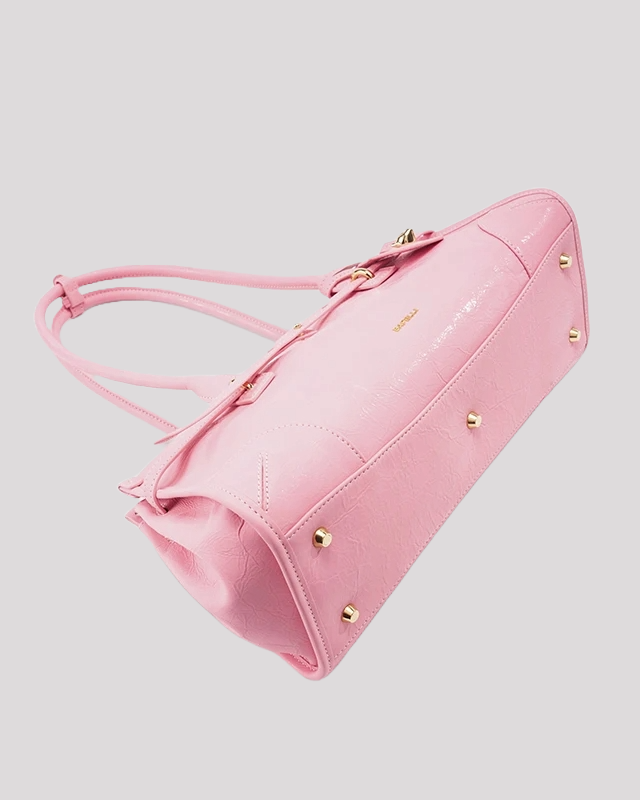 Bottom view of pink leather shoulder bag by Bafelli with protective gold studs