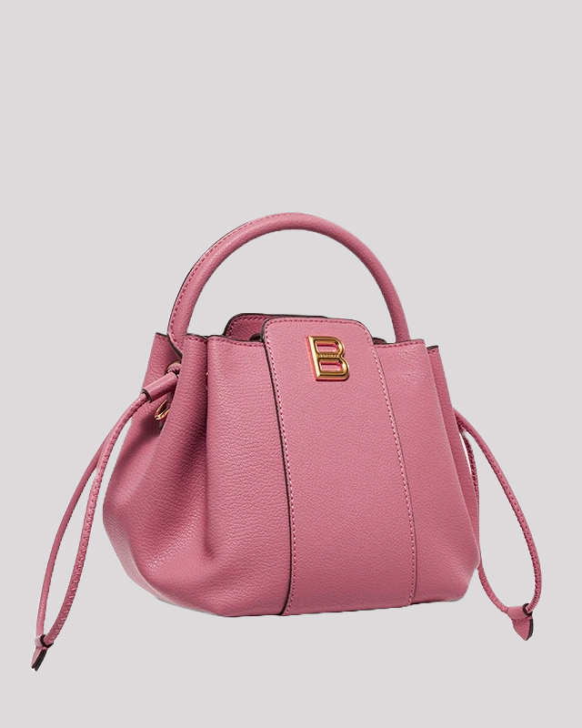 Side angle of pink mini bucket bag by Bafelli showing structured leather and gold "B" logo