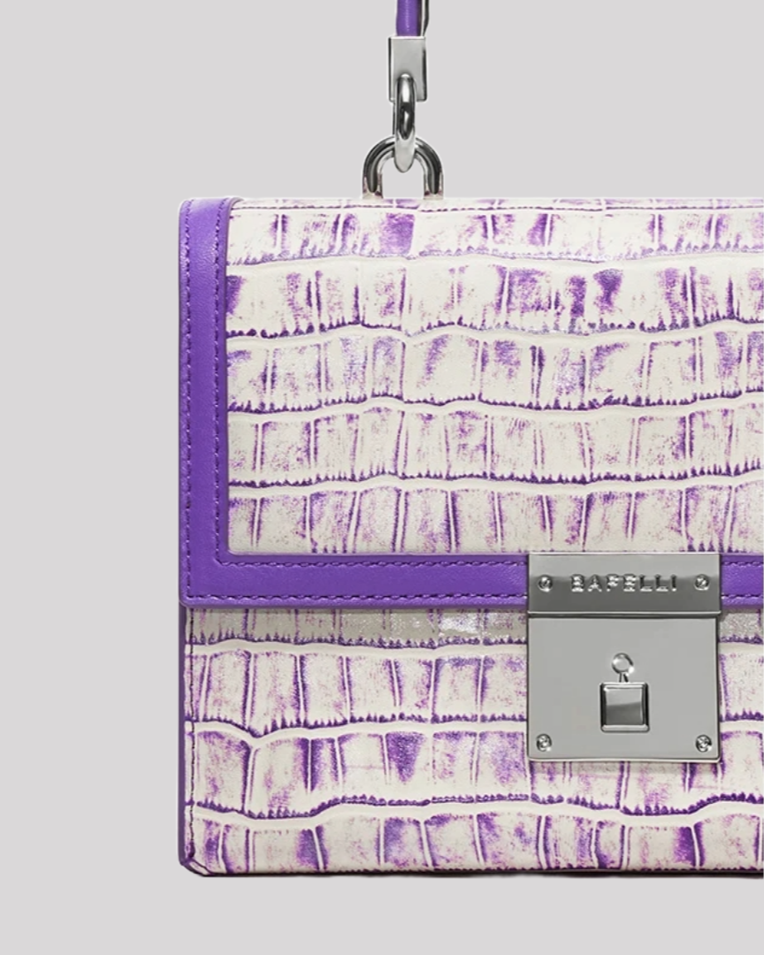 Close-up of purple croc-embossed handbag by Bafelli flap with silver Bafelli clasp detail