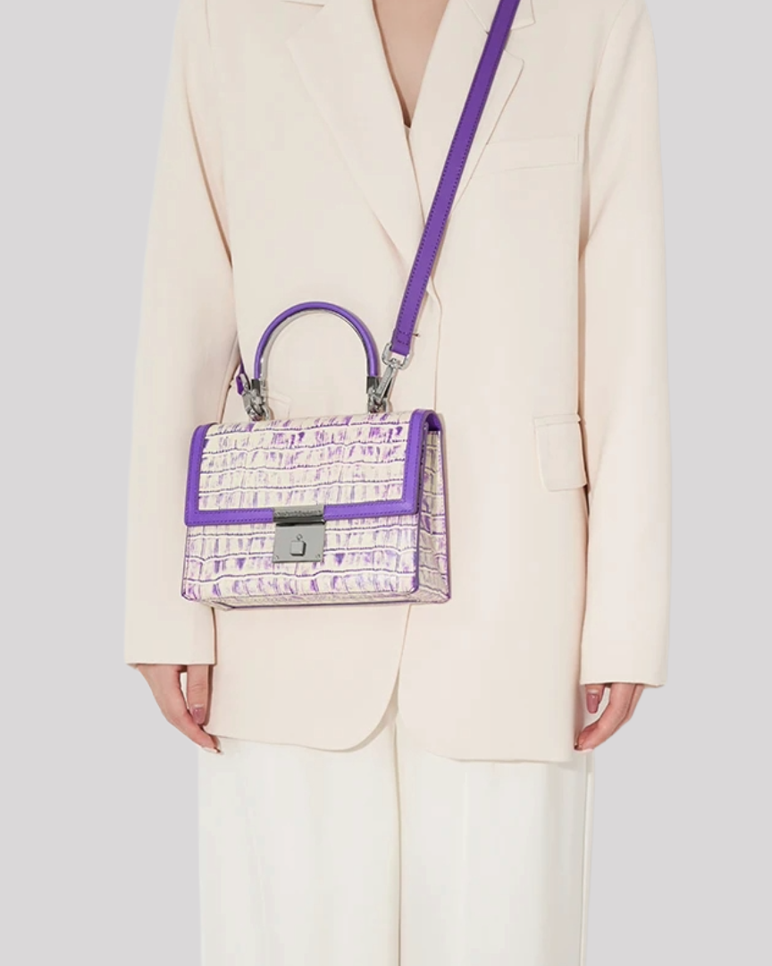 Woman carrying purple croc-embossed handbag by Bafelli with detachable shoulder strap – lifestyle view