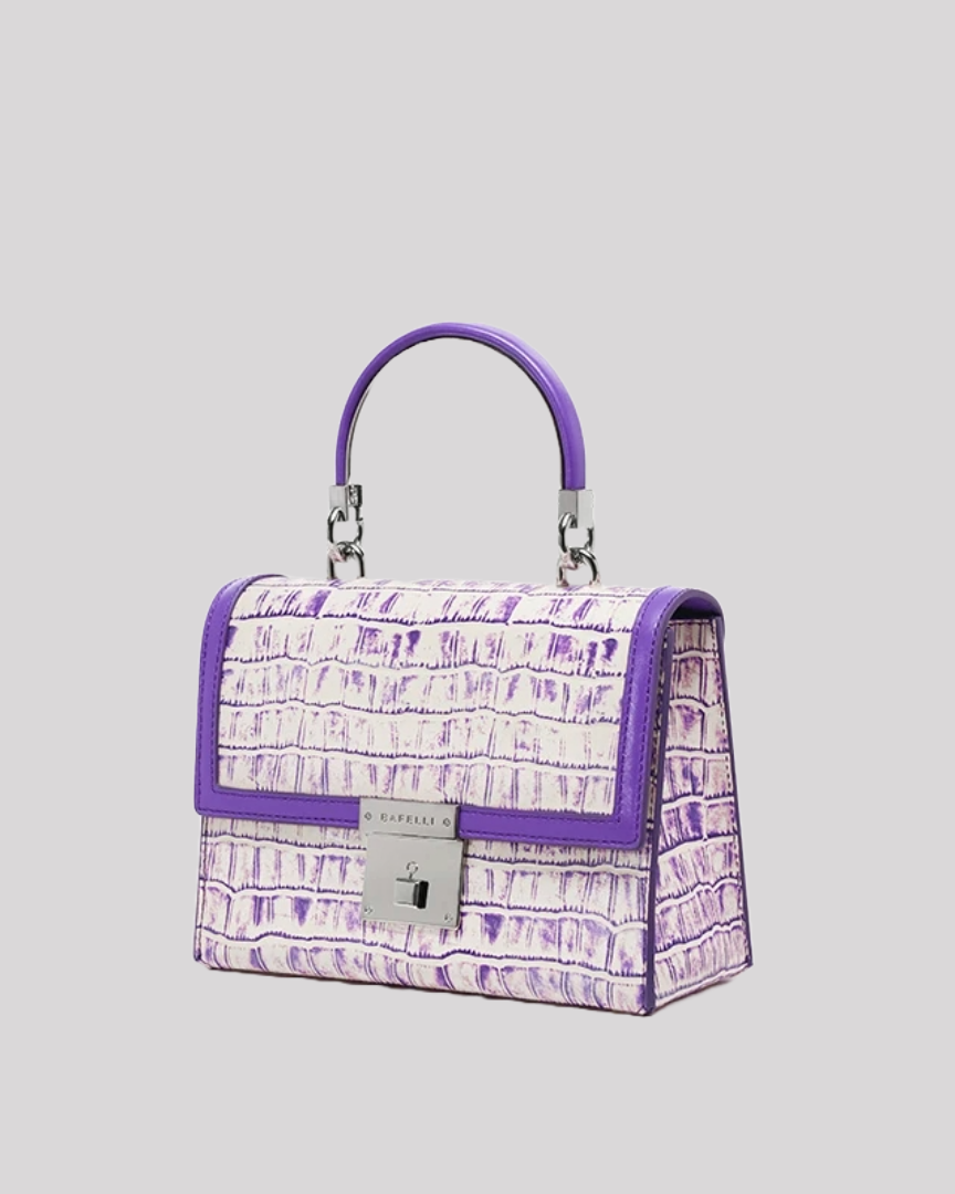 Side angle of purple croc-embossed handbag by Bafelli with structured shape and silver clasp