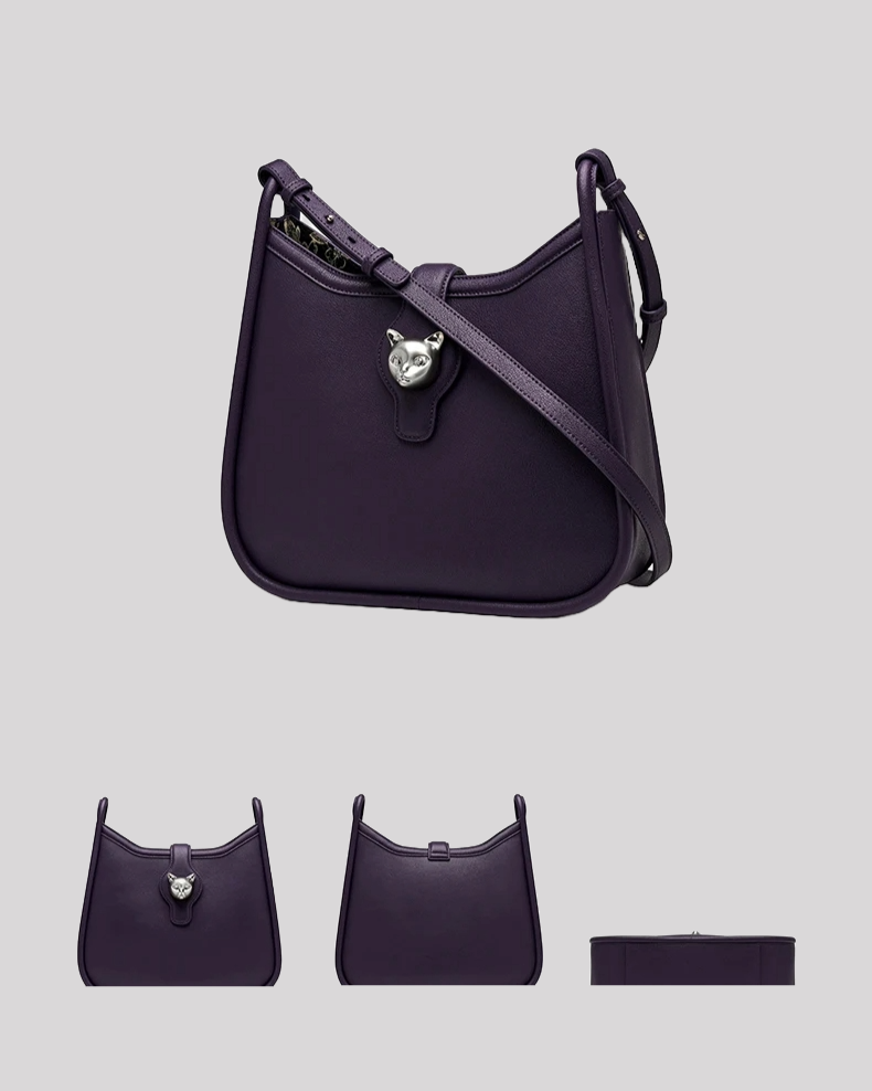 Side angle of purple leather shoulder bag by Bafelli with silver cat head clasp and sleek design