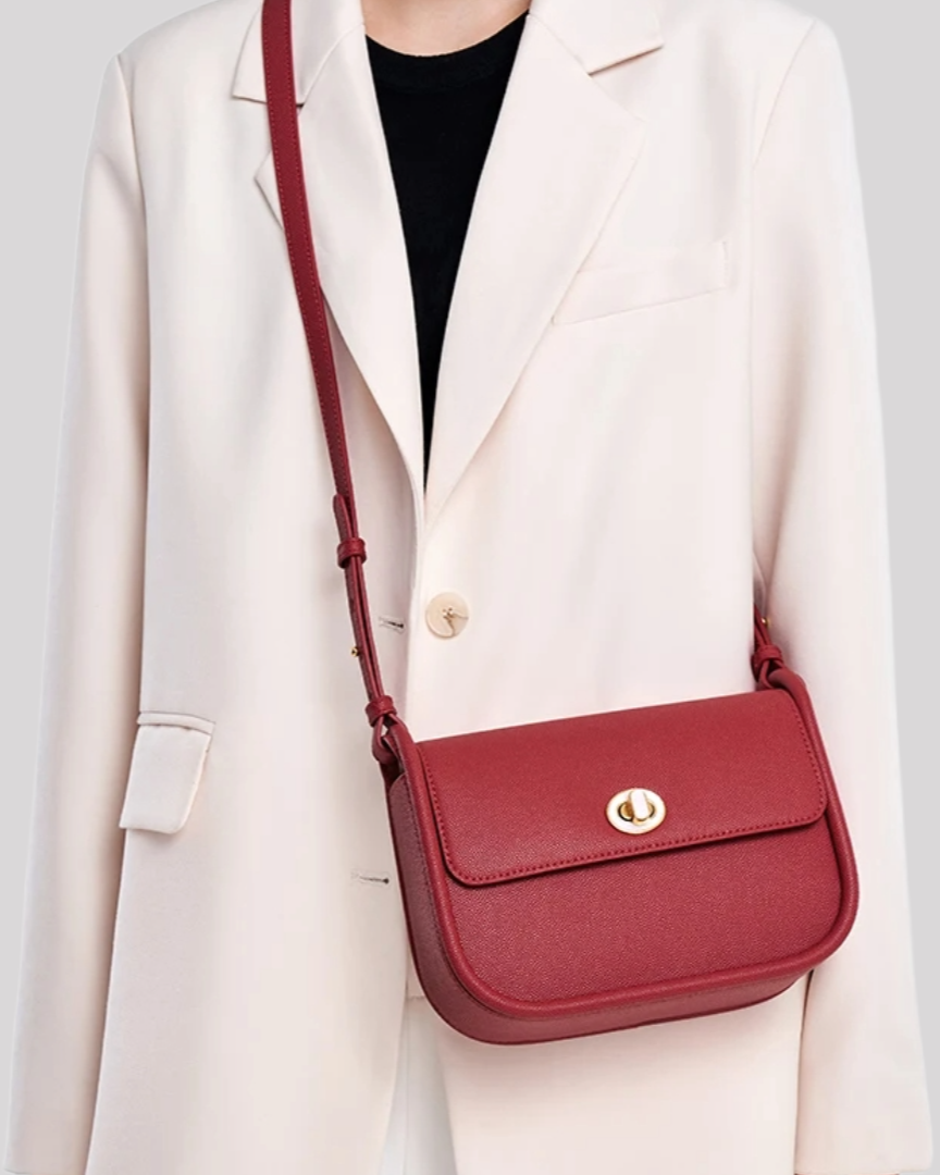 Red crossbody bag by Bafelli styled on model with blazer, highlighting versatile everyday wear