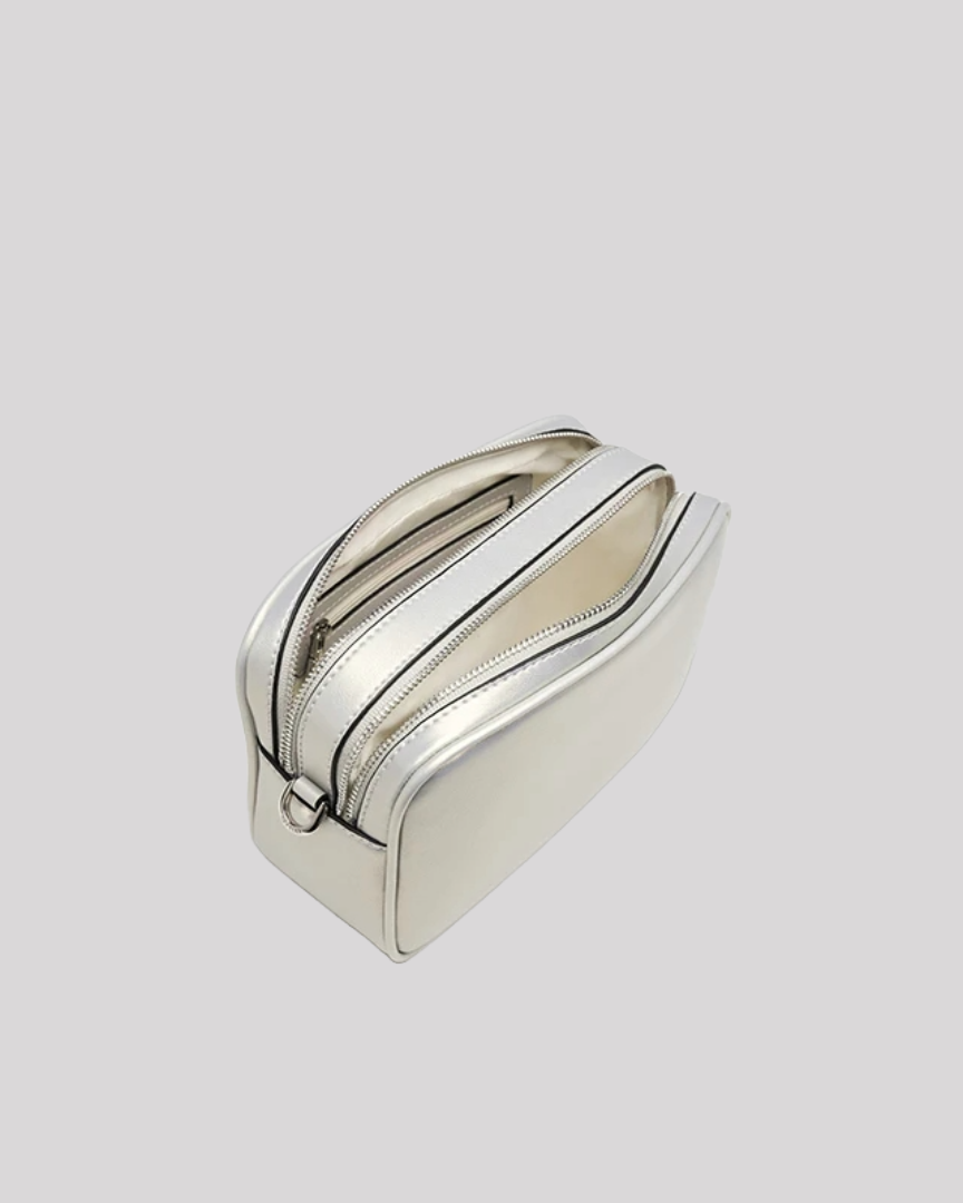 Open top view of silver crossbody bag by Bafelli with dual compartments and light interior lining