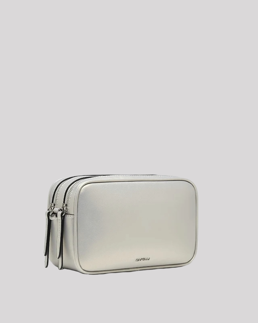 Three-quarter angle of silver crossbody bag by Bafelli showing structured rectangular shape and zippers