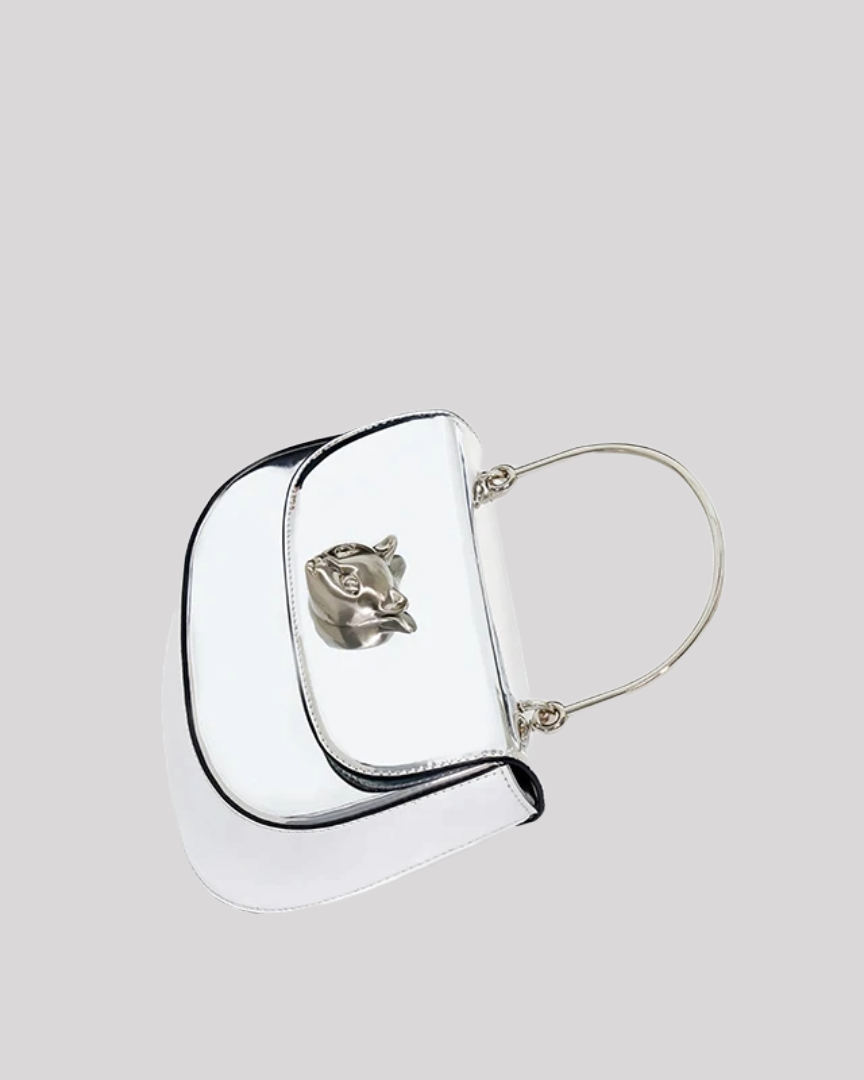 Top view of silver metallic handbag by Bafelli with curved flap and cat emblem
