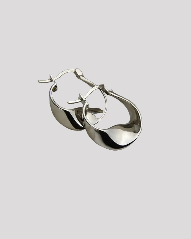 Silver wavy hoop earrings – close-up on gray background