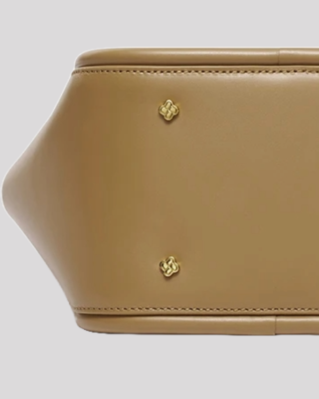 Bottom view of taupe structured leather handbag by Bafelli featuring gold protective studs