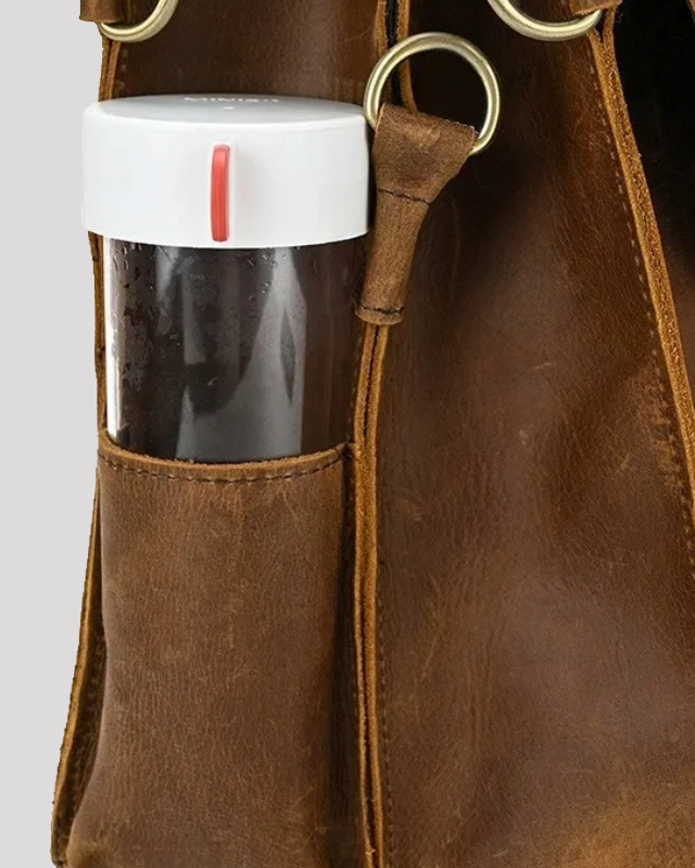 Mocha brown leather messenger bag – side pocket holding a water bottle