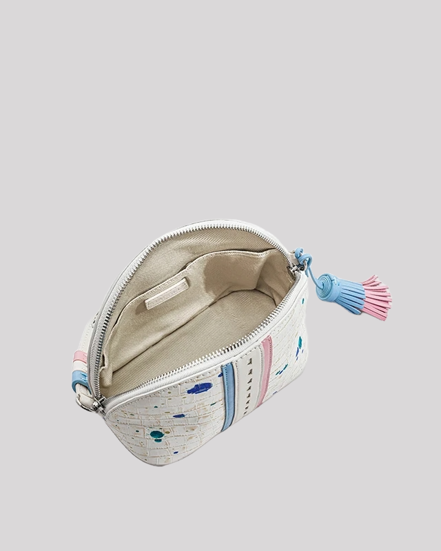 Open view of white wristlet bag by Bafelli showing spacious interior with fabric lining and zip-around closure