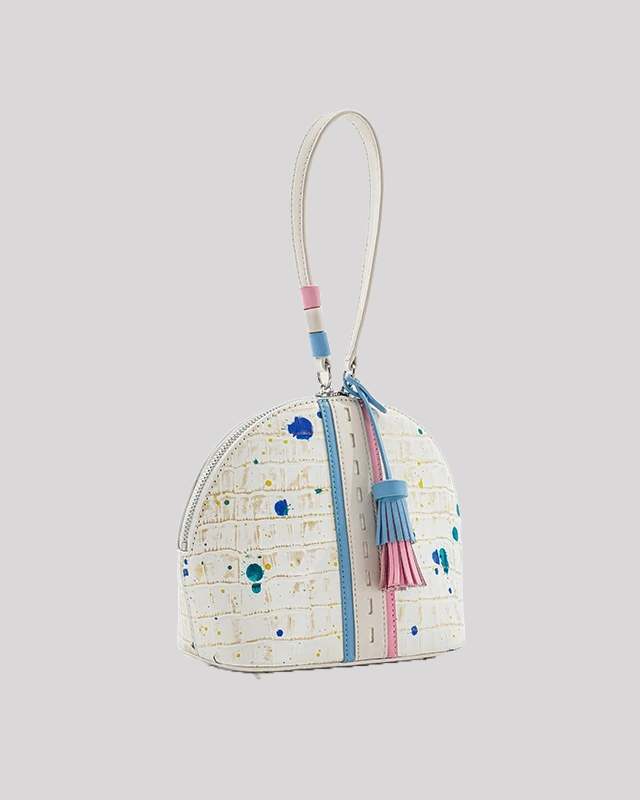 Side view of structured white wristlet bag by Bafelli featuring croc-embossed leather with multicolor paint accents and detachable strap