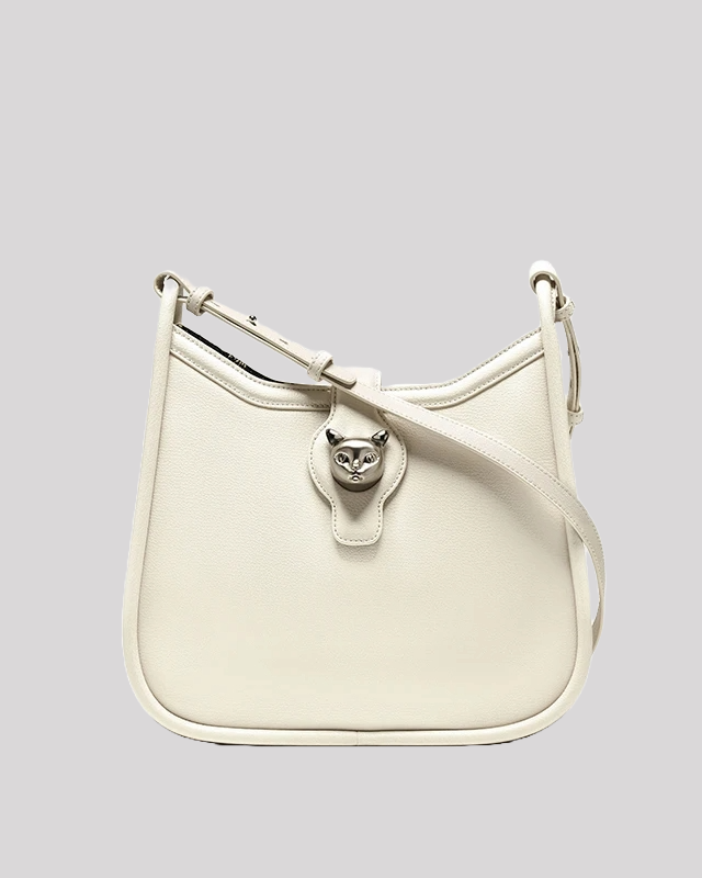 Front view of white leather shoulder bag by Bafelli featuring silver cat head clasp and adjustable strap