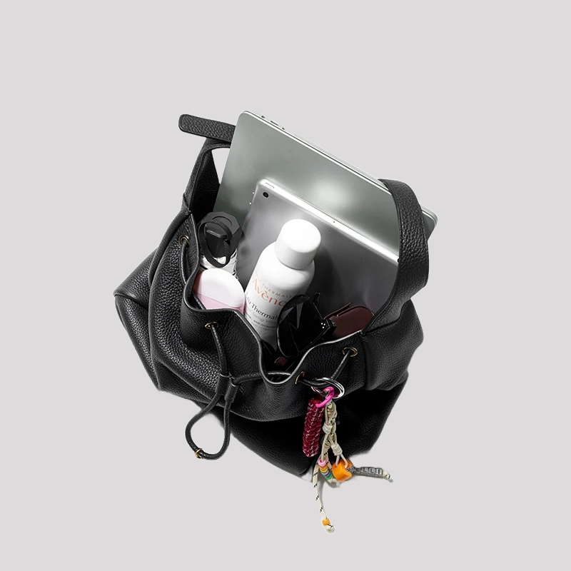 Women’s black leather bucket bag by Bafelli – interior view showing spacious design with laptop, water bottle and daily essentials