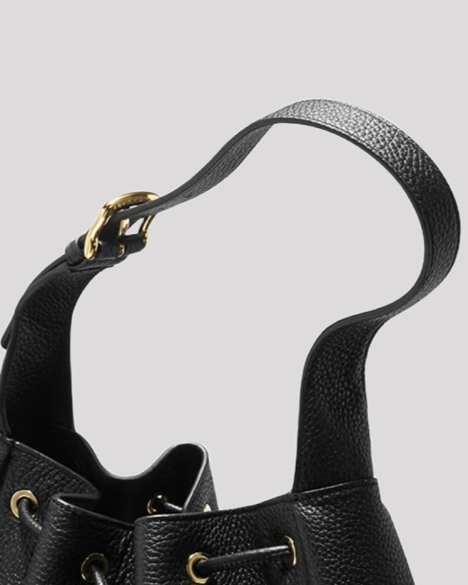 Close-up of women’s black leather bucket bag by Bafelli – adjustable shoulder strap with gold buckle