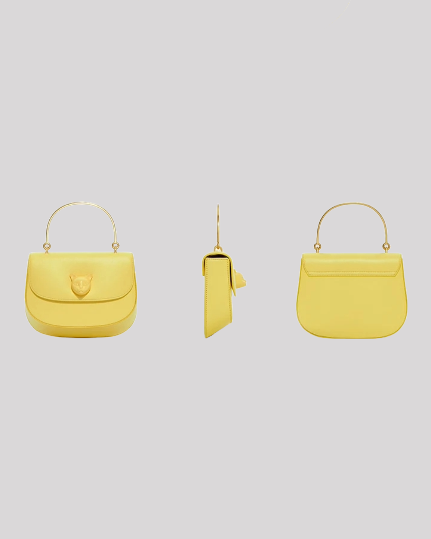 Back view of yellow leather handbag by Bafelli with smooth finish and top handle in gold