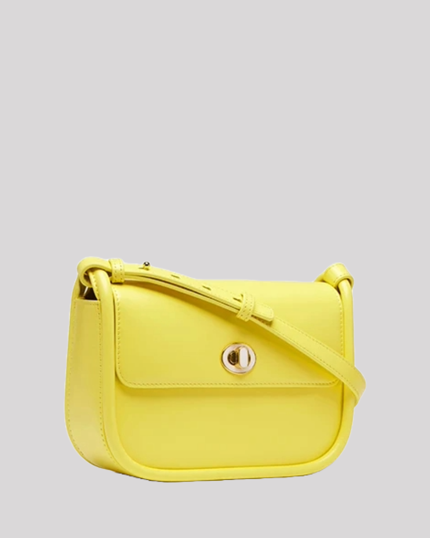 Side angle of structured yellow leather shoulder bag by Bafelli with adjustable strap