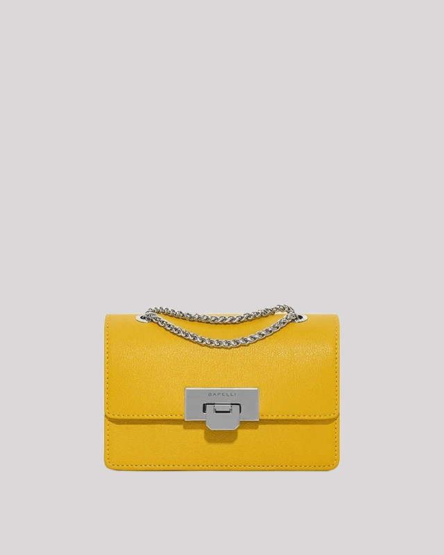 Front view of yellow mini crossbody bag by Bafelli with silver chain strap and metallic clasp closure