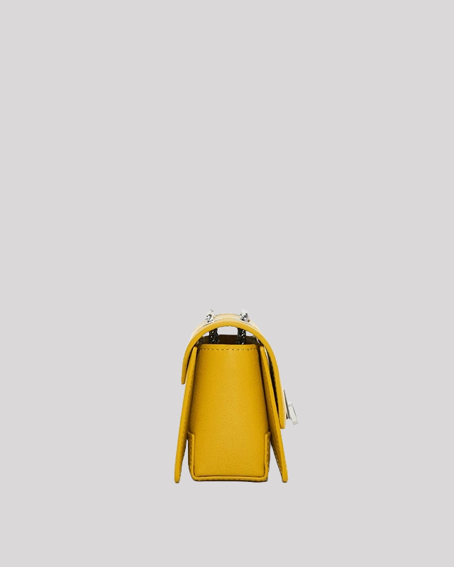Side profile of yellow mini crossbody bag by Bafelli with structured design and chain strap